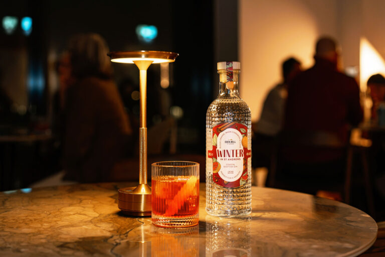 Eden Mill's Winter in St Andrews Gin Bottle on a bar with negroni